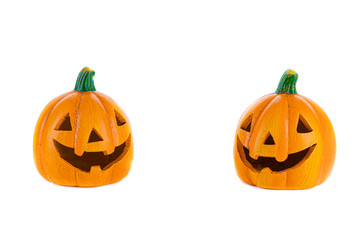 Two orange ceramic pumpkins with eyes, nose and isolated mouth on a white background.