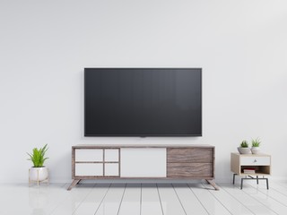 TV on the cabinet in modern living room with plant on white wall background.