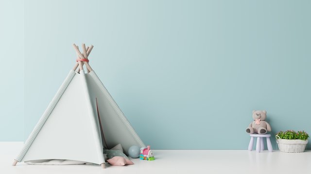 Mock up in children's playroom with tent and table sitting doll on empty blue wall background.