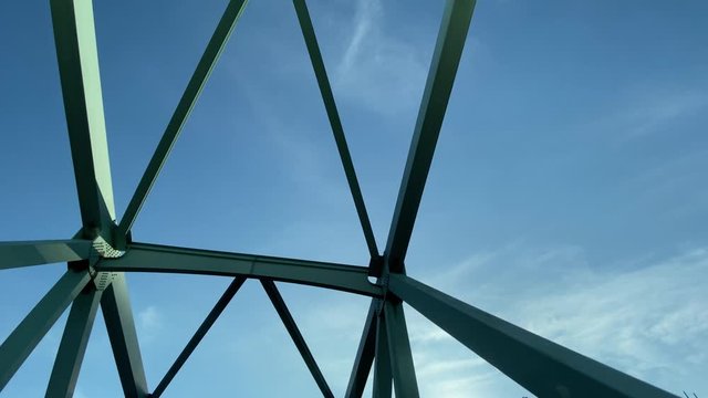 Wide shot view looking up at steel beams on a bridge. Shot at 60fps for optional slow motion use.  	