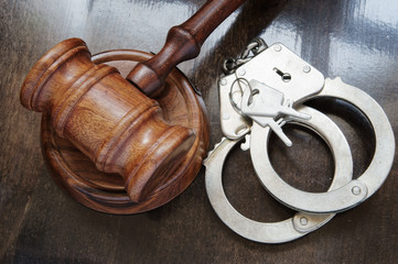 Wooden judge gavel and handcuffs with keys, justice and law concept