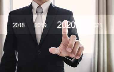 Businessman pressing on 2020. New year business concept