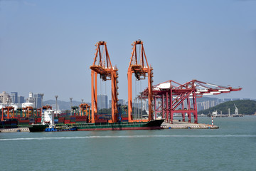 View on the container terminal and gantry cranes loading containers on the cargo ship in the port...