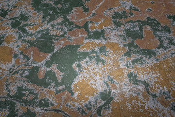 Beautiful patterns on the Old plastered field with falling off flakes of paint. Texture, background, different color patterns.