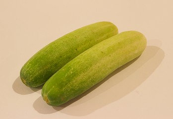 two small green cucumbers