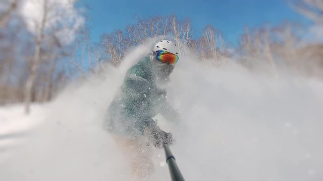 snowboarder making a awesome trick and explodes snow, frame shot on a freeride tour in Kamchatka volcanoes, filmed on the gopro 8 in protune mode
