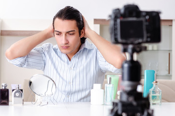 Young handsome man recording his blog in hygiene concept