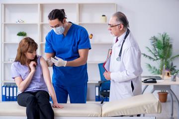 Two doctors examining young woman