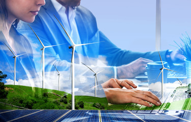 Double exposure graphic of business people working over wind turbine farm and green renewable...