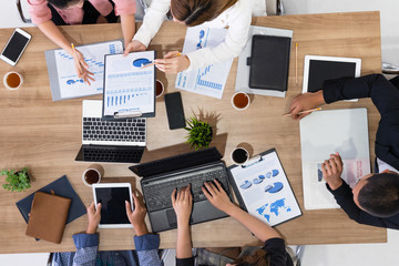 Top view of businessman executive in group meeting with other businessmen and businesswomen in...