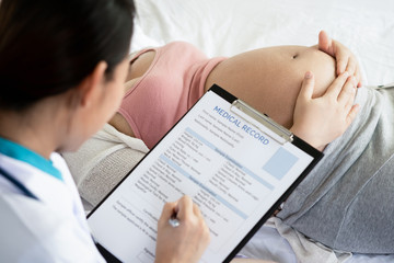 Happy pregnant woman visit gynecologist doctor at hospital or medical clinic for pregnancy...