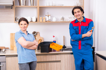 Young male repairman repairing tap