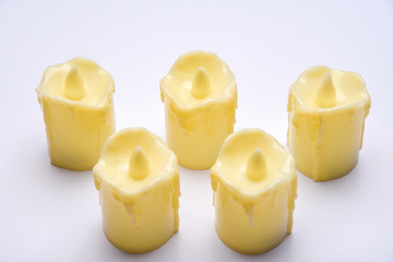 White candle on white background isolated. Set of  candle.Small candle with light yellow spots on light background. Christmas decor