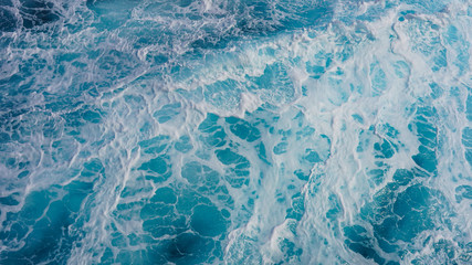 Texture of marine splashes. crashing ocean wave foam structure. Dark blue clear water. Ocean depth.