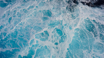 Texture of marine splashes. crashing ocean wave foam structure. Dark blue clear water. Ocean depth.