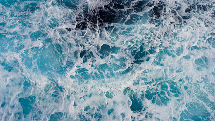 Texture of marine splashes. crashing ocean wave foam structure. Dark blue clear water. Ocean depth.