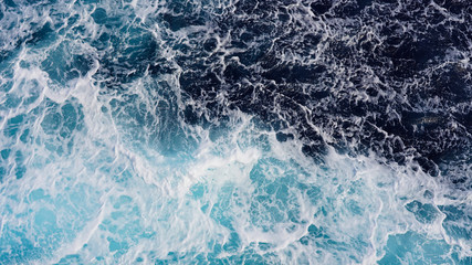 Texture of marine splashes. crashing ocean wave foam structure. Dark blue clear water. Ocean depth.