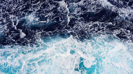 Texture of marine splashes. crashing ocean wave foam structure. Dark blue clear water. Ocean depth.