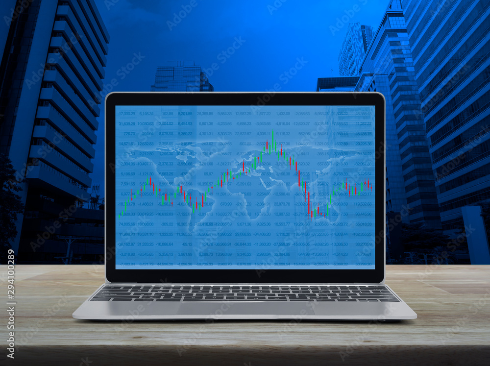 Poster trading graph of stock market with world map and graph on modern laptop computer on wooden table ove