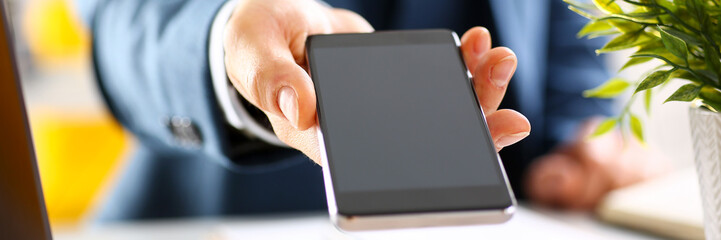 Male arm in suit show in camera phone display screen closeup. Read news mania send sms chat addict use electronic bank modern lifestyle job plan colleague share blog tweet web application search