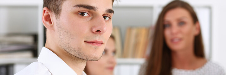 Handsome smiling businessman in suit portrait at workplace look in camera. White collar worker at...