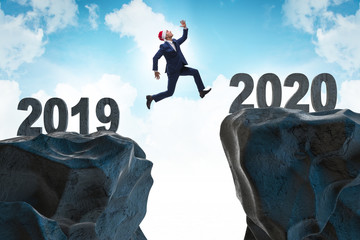 Businessman jumping from year 2019 to 2020