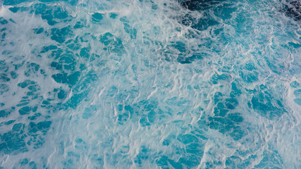 Texture of marine splashes. crashing ocean wave foam structure. Dark blue clear water. Ocean depth.