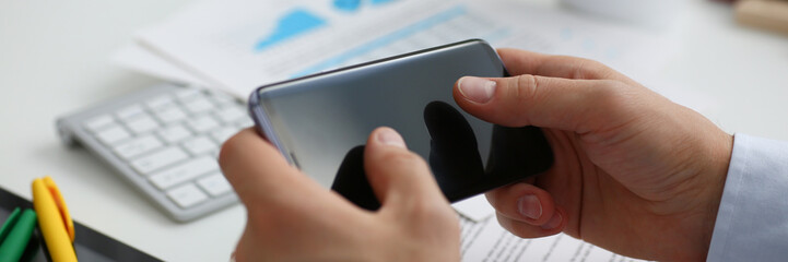 Businessman holds a new smartphone in his hand The mobile application market shows a display you...