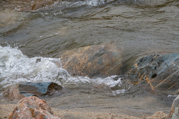 Clear water flowing over colourful rocks, Cornwall