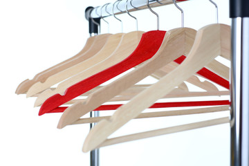 Red and wooden hanger hanging on metal pipe business leader selling clothes and style