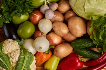 Fresh vegetables on wooden background, top view