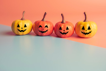Halloween concept, Four Pumpkin with smile face on pastel colors background.
