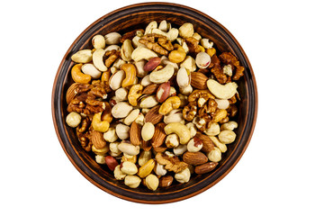 Bowl with mixed nuts isolated on white background. Walnuts, pistachio, almond, peanut, cashew, hazelnut in ceramic bowl. Top view