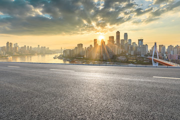 Asphalt highway and modern city financial district skyline in Chongqing at sunset,China.
