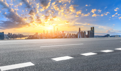 Asphalt highway and modern city financial district skyline in Chongqing at sunset,China.