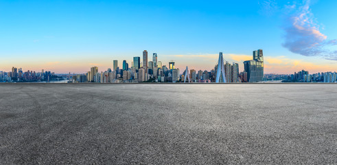 Empty race track ground and city financial district with buildings in Chongqing at sunrise,China.