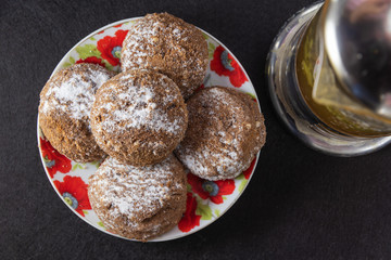 Delicious pastry on a dark background in white crockery and tea