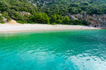 Hidden Lubenice beach in Cres island Croatia with crystal clear turquoise water
