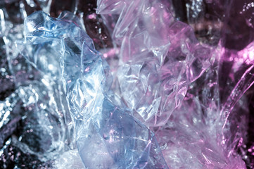 Holographic background in the style of the 80-90s. Real texture of cellophane film in bright acid colors.