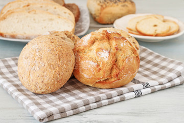 Buns and breads on breakfast table.
