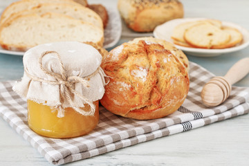 Buns and breads on breakfast table.