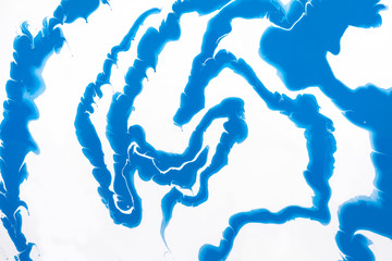 Acrylic Fluid Art. Glowing blue waves and swirls on a white background. Abstract marble background...