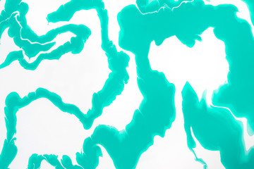 Mint green waves and swirls on a white background. Abstract marble background or texture. Acrylic...