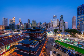 Buddha Tooth Relic Temple and Singapore cityscape at dusk