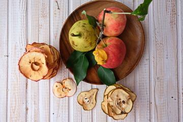 Organic Apple chips (slices) on a white background is a healthy vegetarian fruit snack or cooking ingredient. The concept is a healthy