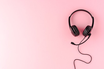 Overheadshot of headset on background with copyspace. Call center concept