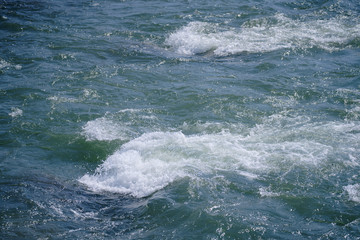 Rapid water splashes through the river