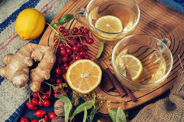 Two cups of medicinal herbal tea with ginger, lemon, cinnamon and lime.  Tonic and therapeutic hot drinks .