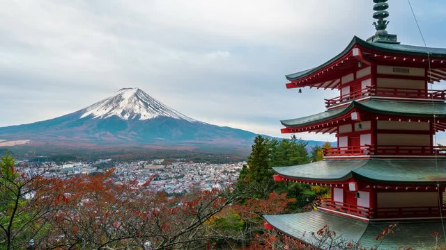 4K motion Time lapse of mount Fuji and Chureito Pagoda at sunrise in autumn. Chureito pagoda is located in Fujiyoshida, Japan. Mount Fuji or Fuji san is the most famous natural landmark in Japan.