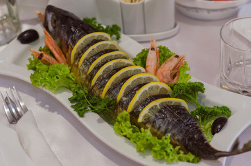 dish stuffed pike garnished with lemon